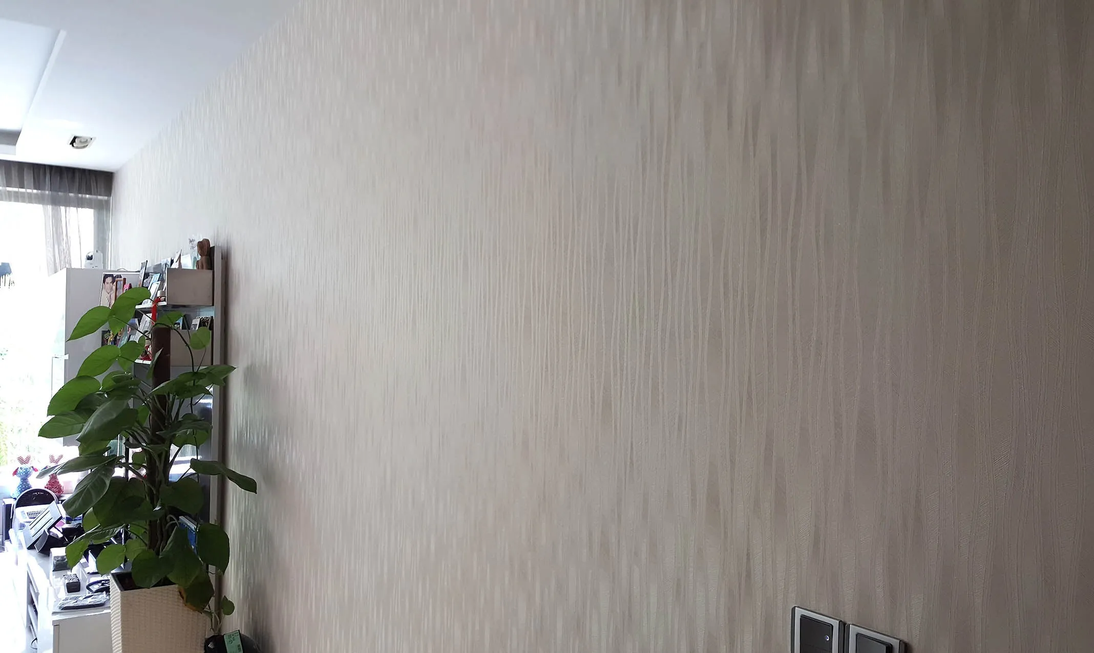 textured beige wallpaper accent wall
